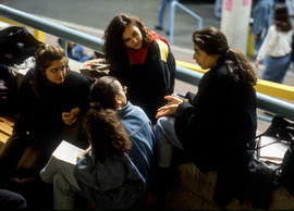 Photograph of students sitting in a huddle in the Student Centre