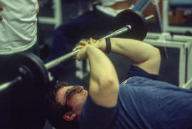 A photograph of a student about to do a bench press
