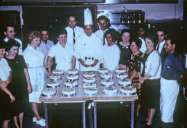 Photograph of Food Services staff displaying decorated cakes
