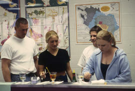 A photograph of students mixing drinks in the Bartending lab
