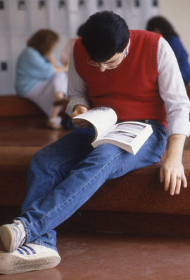 Photograph of a student reading a book