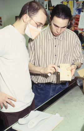 A photograph of Industrial Design students carving their designs with wood blocks