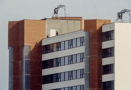 Photograph of maintenance workers on the roof of student residence