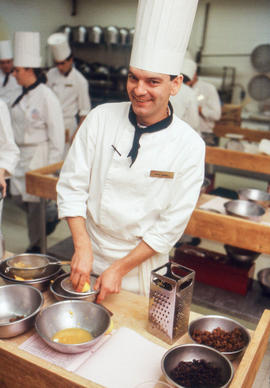 Photograph of a student chef juicing a lemon
