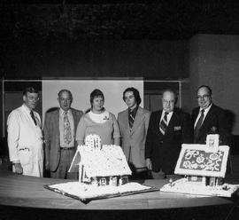 Photograph of Gordon Wragg and Igor Sukor Displaying the Gingerbread Houses to the Hospital Execu...