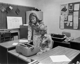 Photograph of Two Students Working Together in the Business Secretarial Program Typing Lab