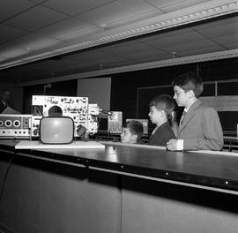 Photograph of young visitors looking at electronic equipment during an open house