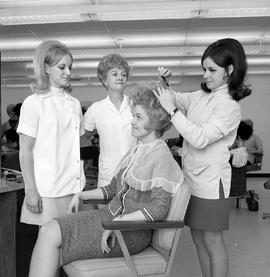 Photograph of Hairdressing students practicing hair teasing techniques