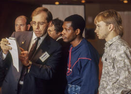 Photograph of a CASIO electronics representative showing students a CASIO calculator