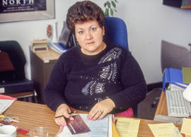 Photograph of Maria Gonsalves at her desk