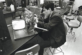 Photograph of an Electronics Student Testing Circuits