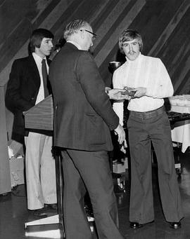 Photograph of Gordon Wragg Presenting an Award to a Student at the Athletic Awards Banquet