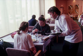 Photograph of Hotel and Restaurant student serving customers in the Humber Room