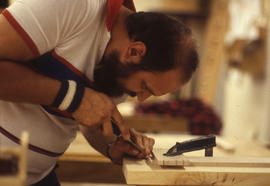 Photograph of a Woodworking student using a mortise channel in a block