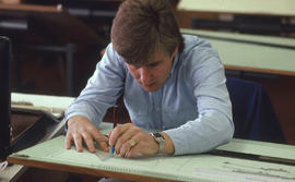 Photograph of a student working at a drafting table