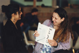 Photograph of two students looking at a book
