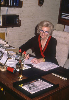 Photograph of Marni McAlpine Sitting at her Desk