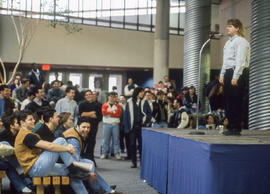 Photograph of a speaker onstage in front of an audience