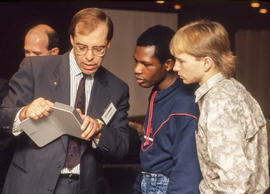 Photograph of a CASIO Electronics representative showing features of a calculator