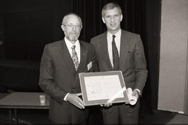 Photograph of Humber president Dr. Robert A. Gordon presenting an award to Arie Nadler