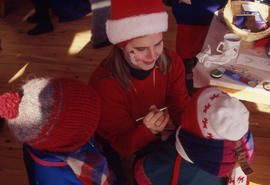 Photograph of a Kid Getting Their Face Painted During the Christmas Tree Sale and Family Event