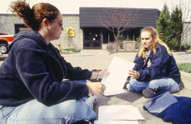 A photograph of students sitting outside Building G