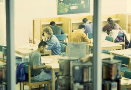 A photograph of students sitting at study carrels