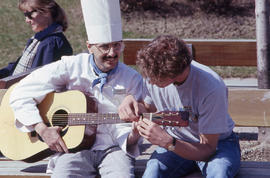 Photograph of student chef learning to play the guitar