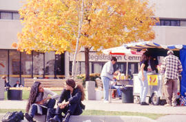 Photograph of students gathered at the hot dog vendor outside the Registration entrance