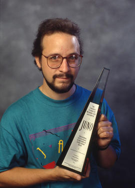 Photograph of Brian Dickenson with a JUNO award
