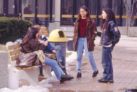 Photograph of students seated on a bench outdoors