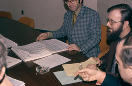 Photograph of Bob Caco and Bev Walden in a Staff Meeting