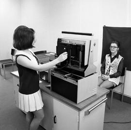 Photograph of Polaroid equipment being used to take photographs for student identification cards