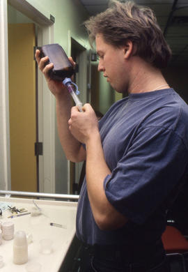 Photograph of a Pharmacy Assistant student loading a syringe