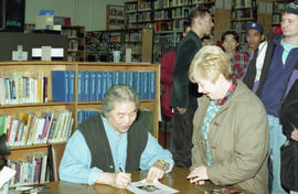 Photograph of Wayson Choy signing a poster