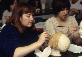 A photograph of students in the Funeral Services program working on mannequins