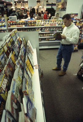 A photograph of a student reading a magazine at the Bookstore