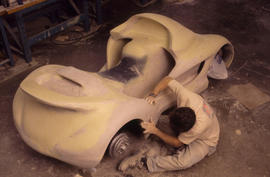 Photograph of student working on a model car
