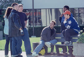 Photograph of students seated outdoors on a bench