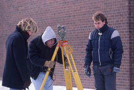 Photograph of students working with survey equipment in winter