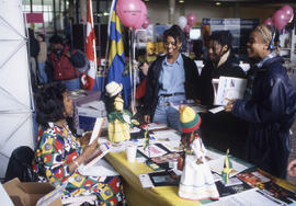 Photograph of People Visiting a Booth in the Concourse During International Day