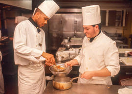 Photograph of students in the Culinary program straining sauce