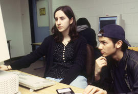 A photograph of two students working together at a computer