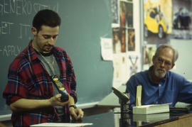A photograph of Industrial Design student presenting his design to the class