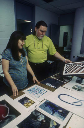 Photograph of two faculty members reviewing students work
