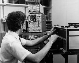 Photograph of Max Ward Testing a Video Tape Recorder in his Office