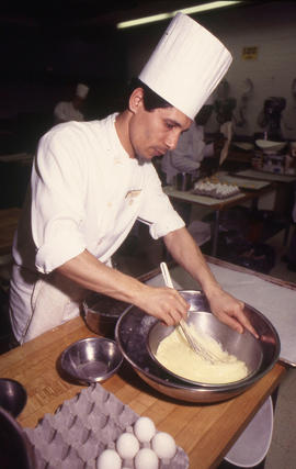 Photograph of a culinary student at work in the culinary lab