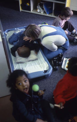 Photograph of an Early Childhood Education student attending to a child