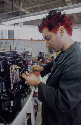 Photograph of student working on a small engine