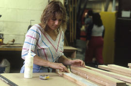 Photograph of a student gluing wood strips in the Workshop